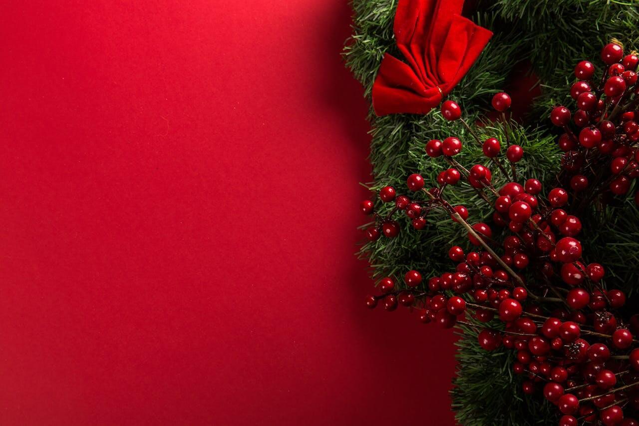 Christmas wreath with red berries and a velvet bow
