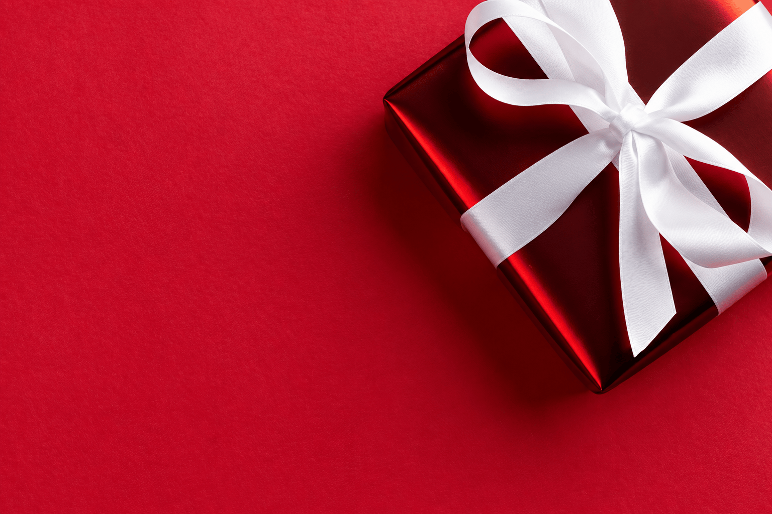 Red gift box with a white ribbon